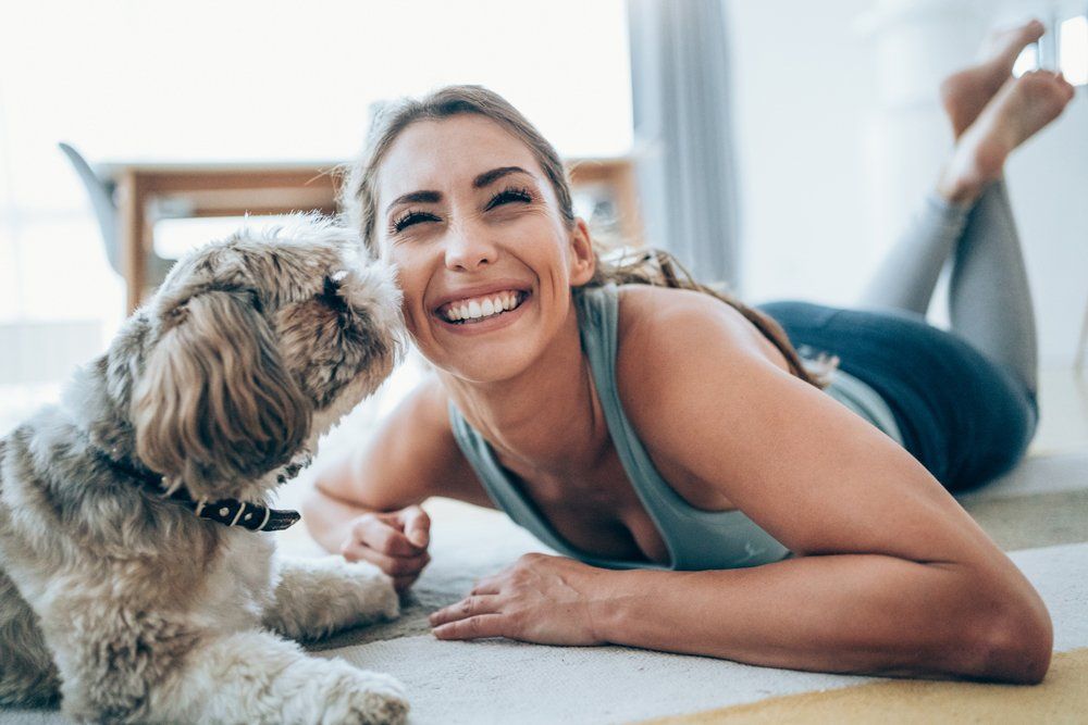 Smiling Woman With Her Dog — Riverdale, GA — Tara Gynecology