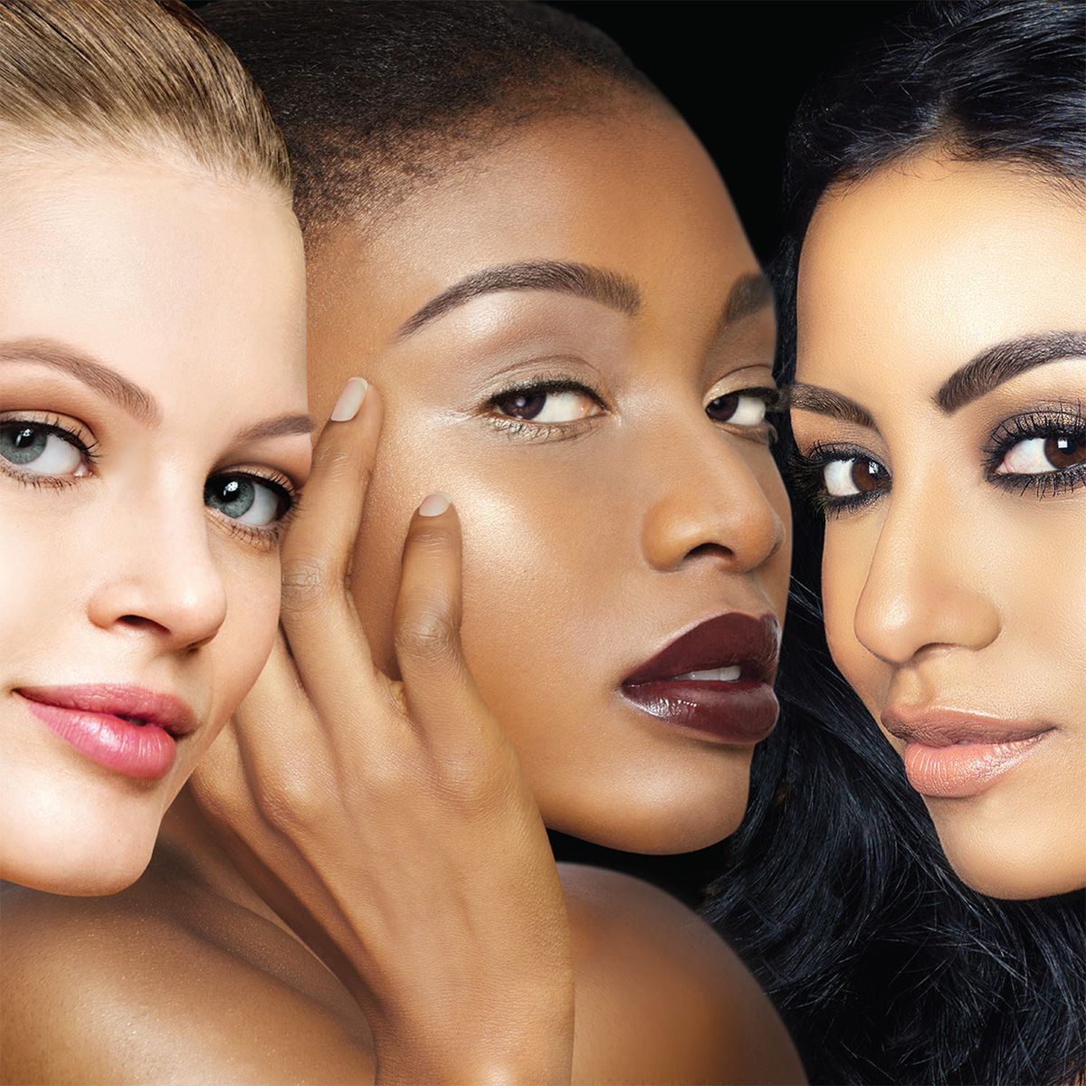 Three women with different skin tones are posing for a picture