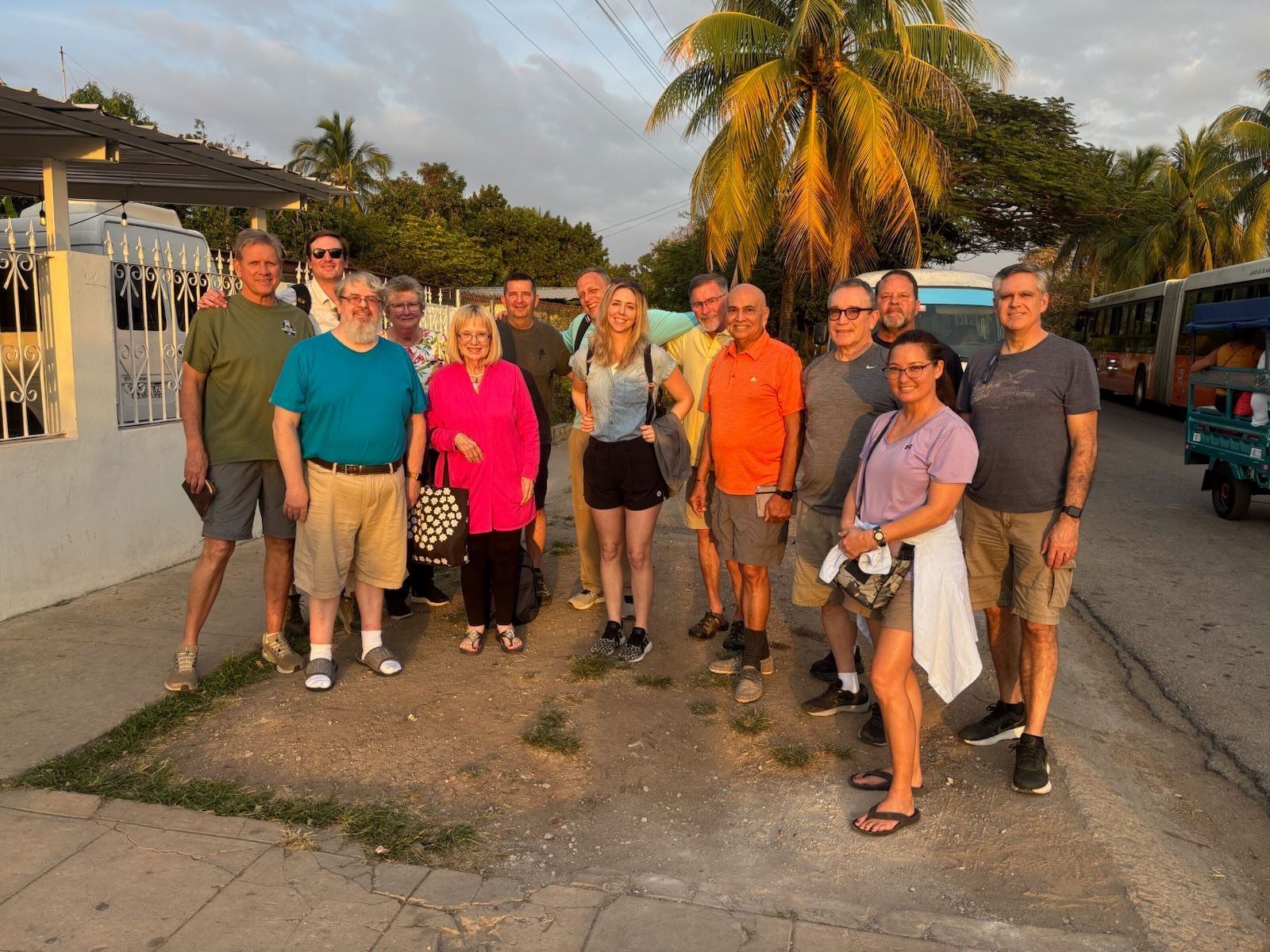 A group of people are posing for a picture on the side of the road.