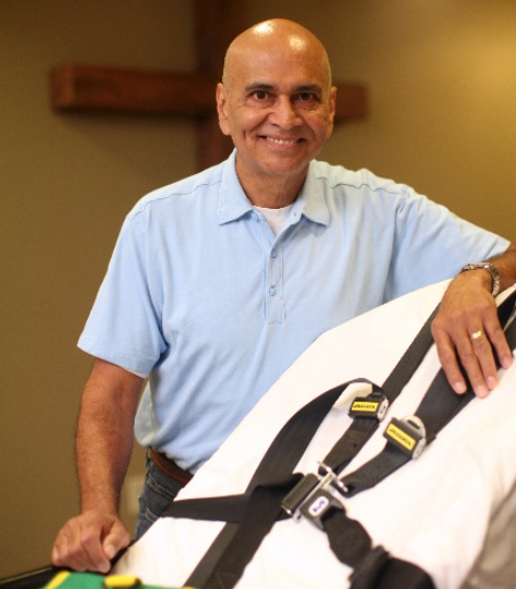 Two men are posing for a picture together and smiling for the camera.