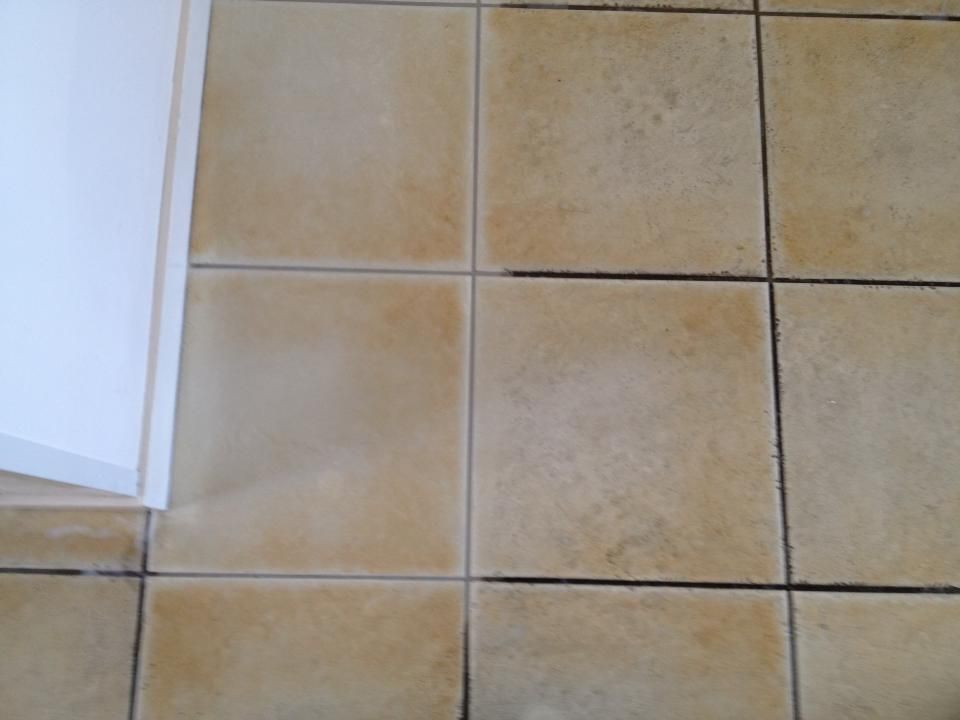Tan Tiled Floor With Dark Grout Next to a White Cabinet — Ultimate Restoration Services in Koongal, QLD