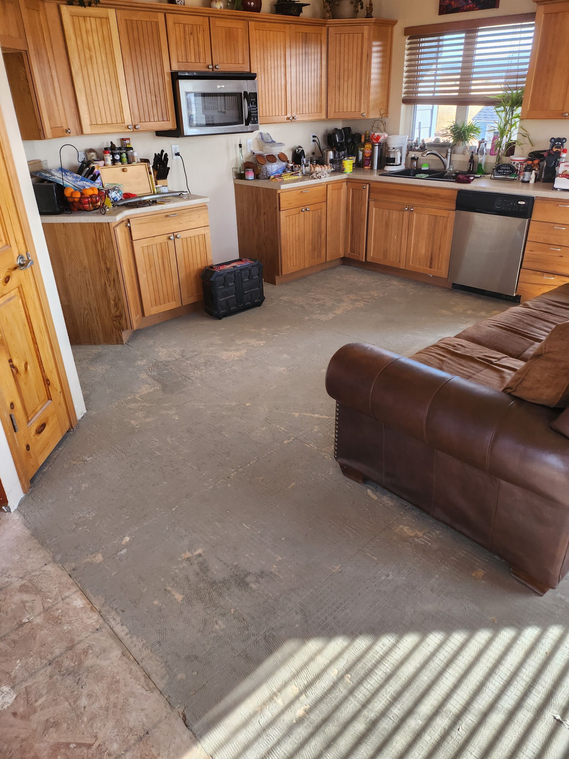 A kitchen with wooden cabinets and stainless steel appliances