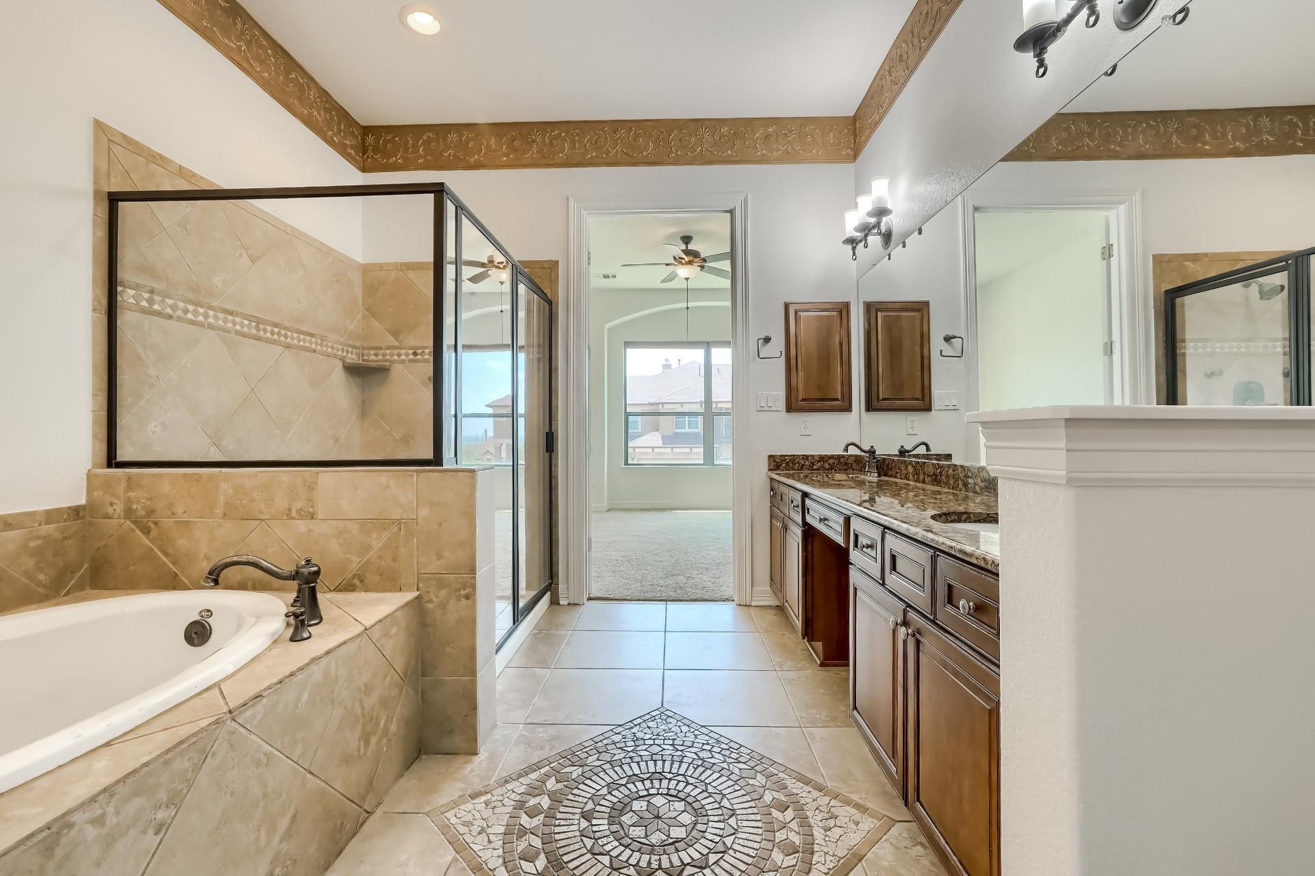 A modern bathroom with a large oval bathtub, sleek glass shower, and polished concrete walls, featuring a minimalist white vanity and industrial-style lighting