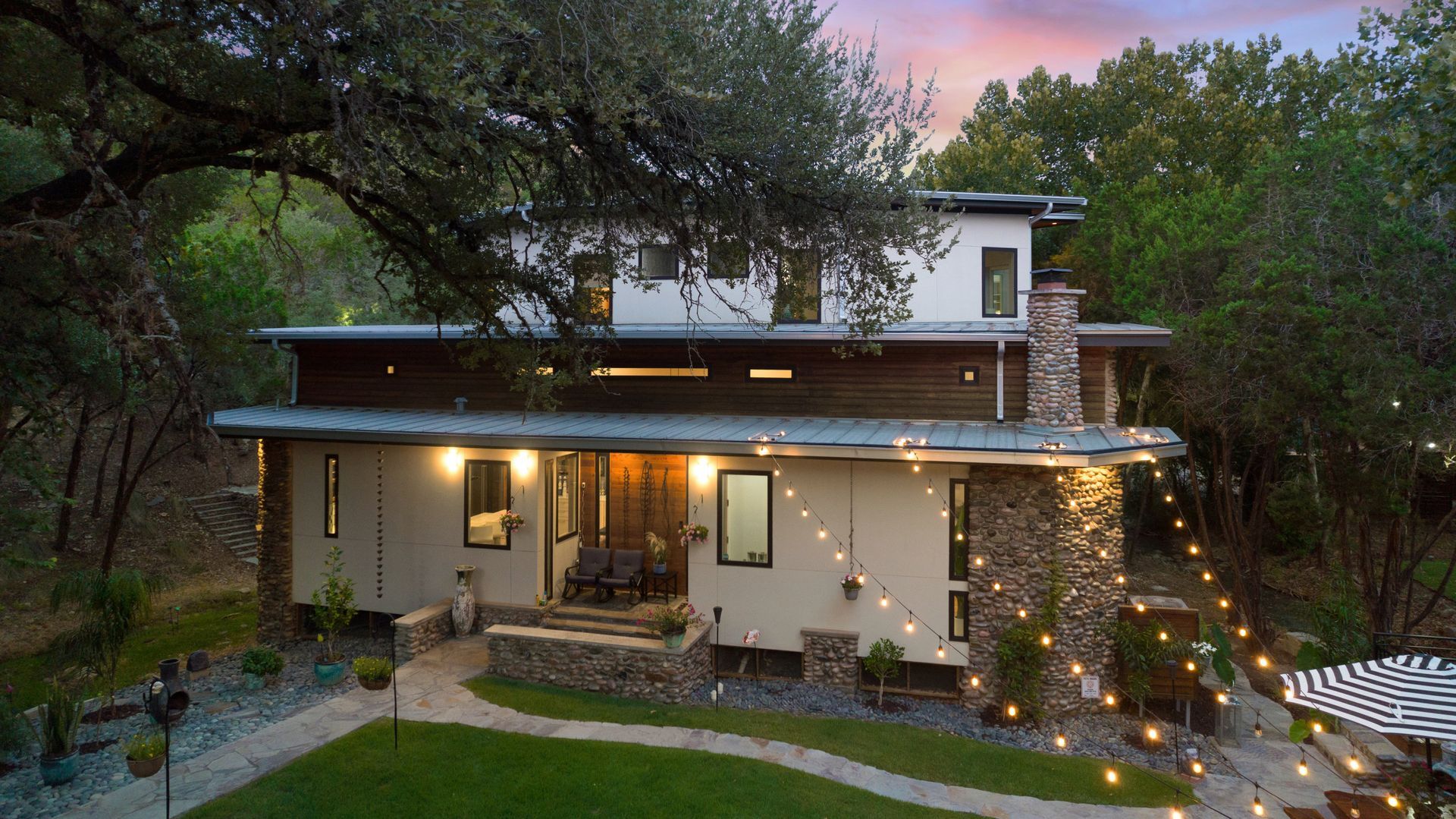 Home exterior with hanging lights on backyard