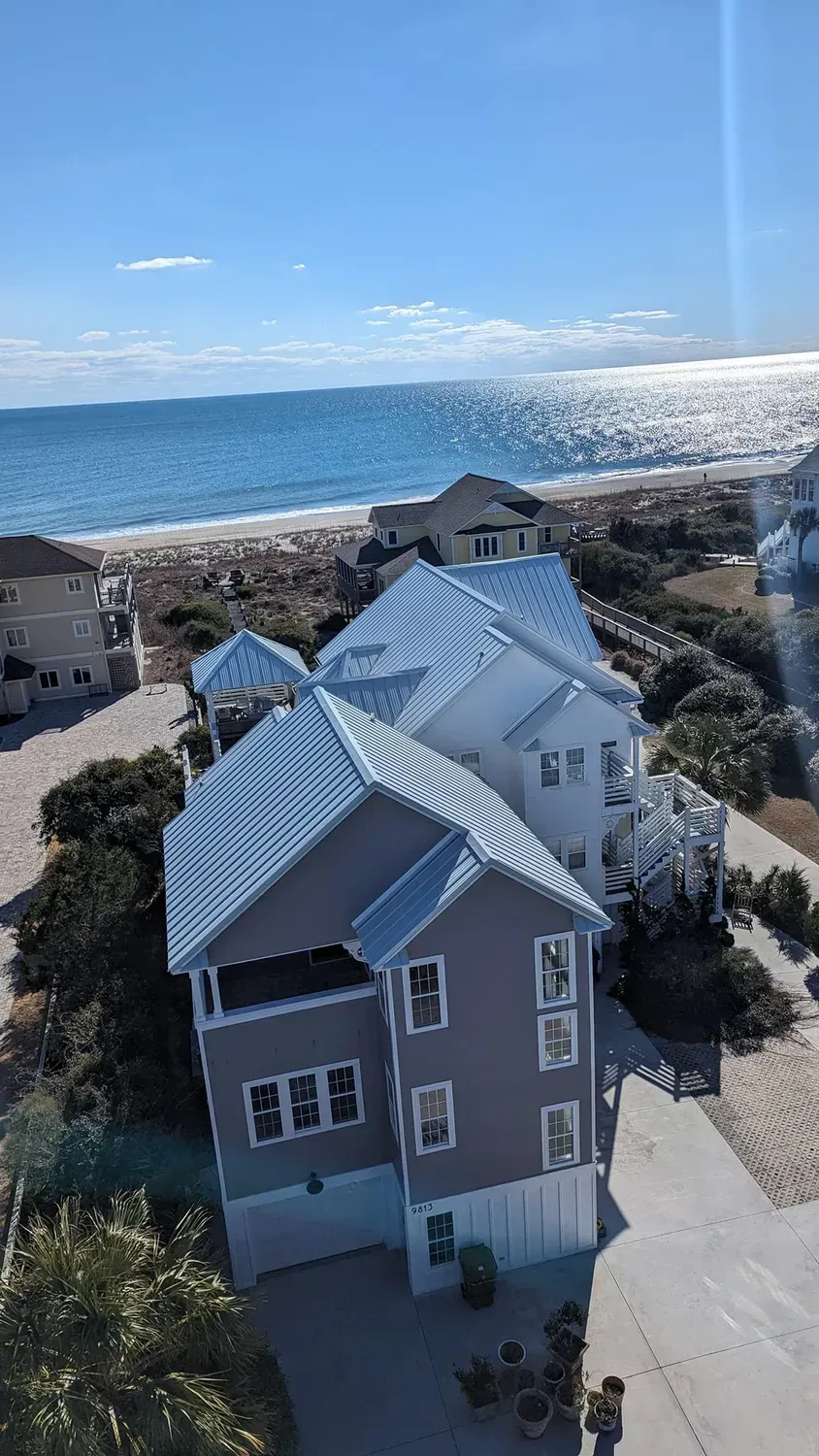 An aerial view of a house with a view of the ocean.