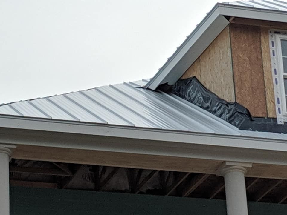 A house under construction with a metal roof