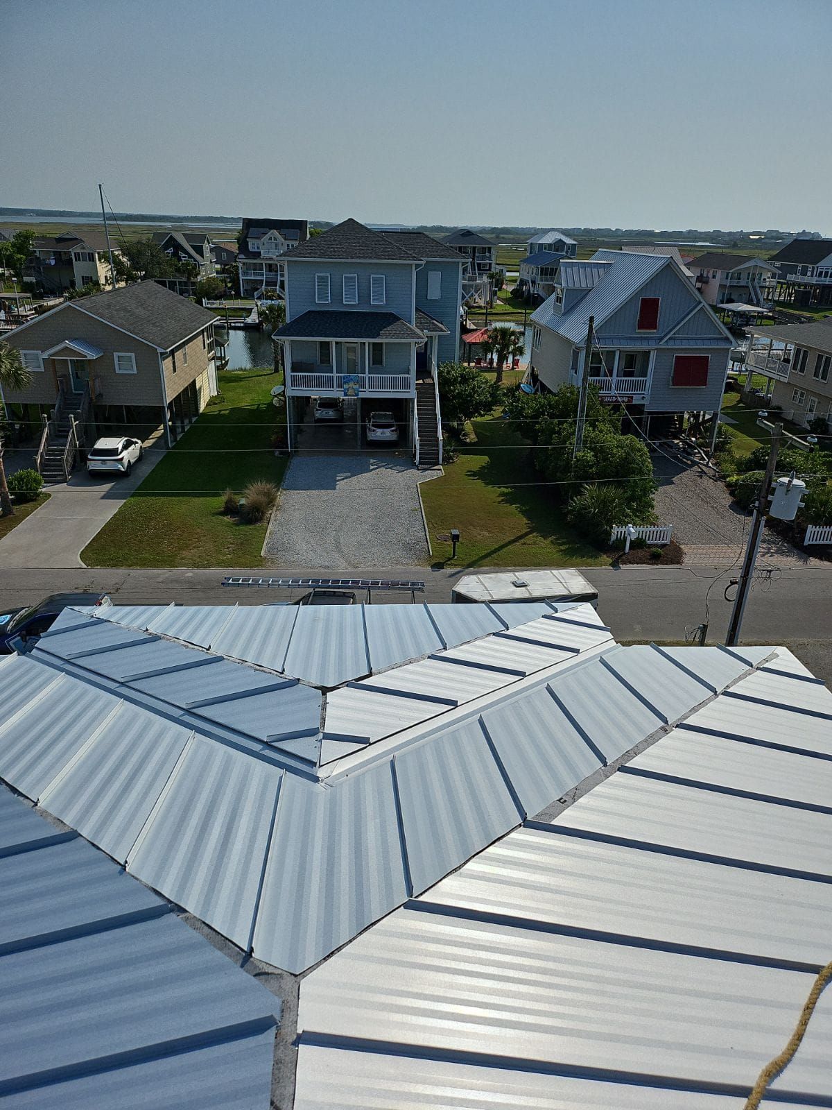 An aerial view of a residential area with houses and a roof