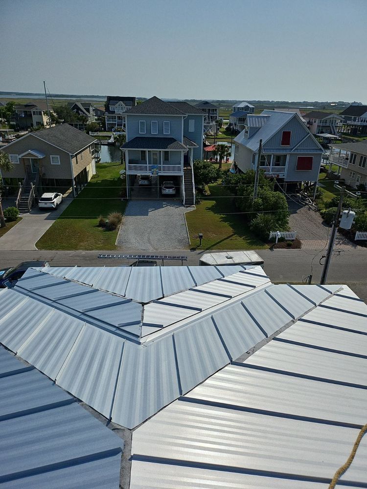 An aerial view of a house with a metal roof