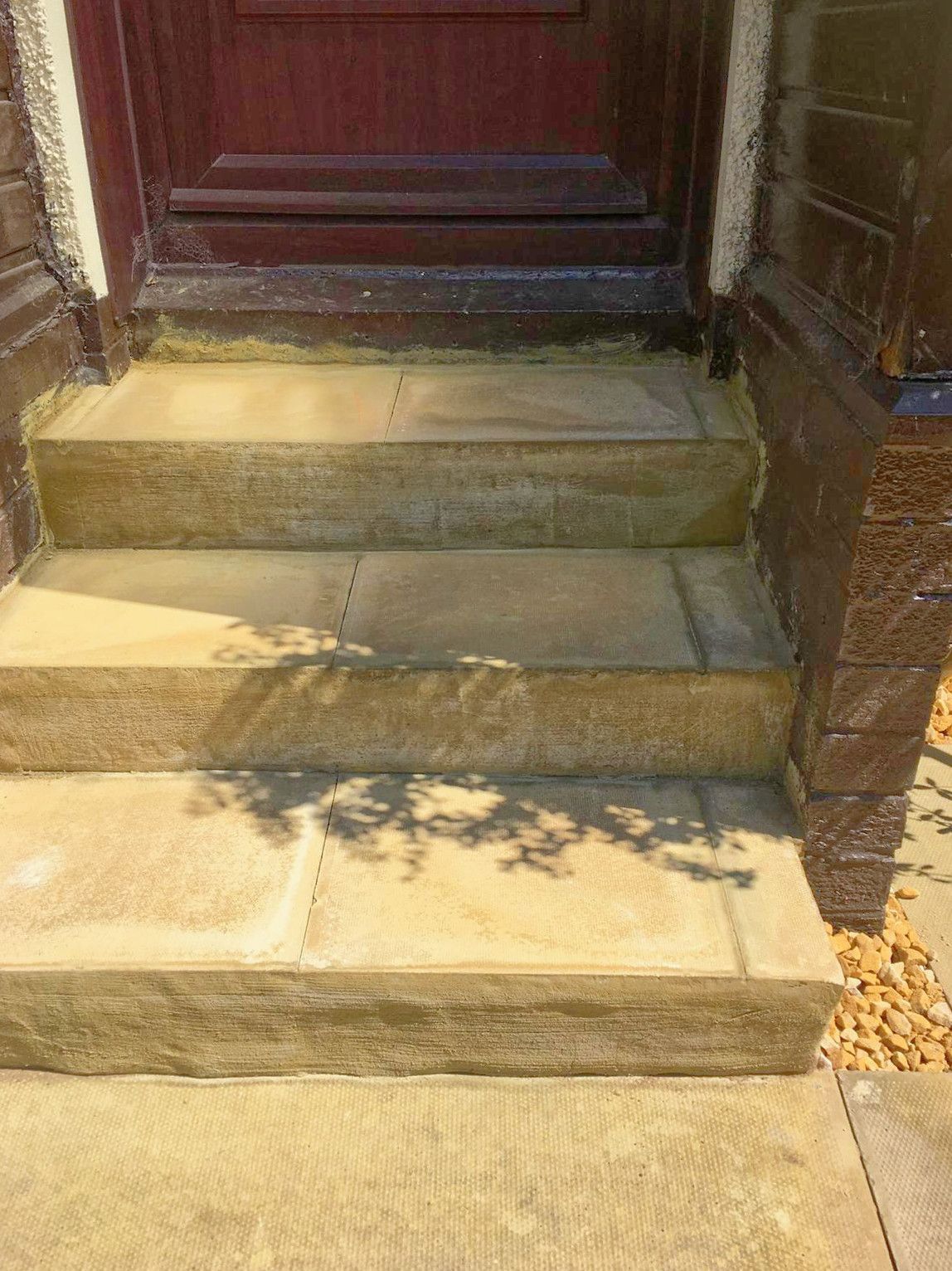 A close up of a set of stairs leading up to a door.