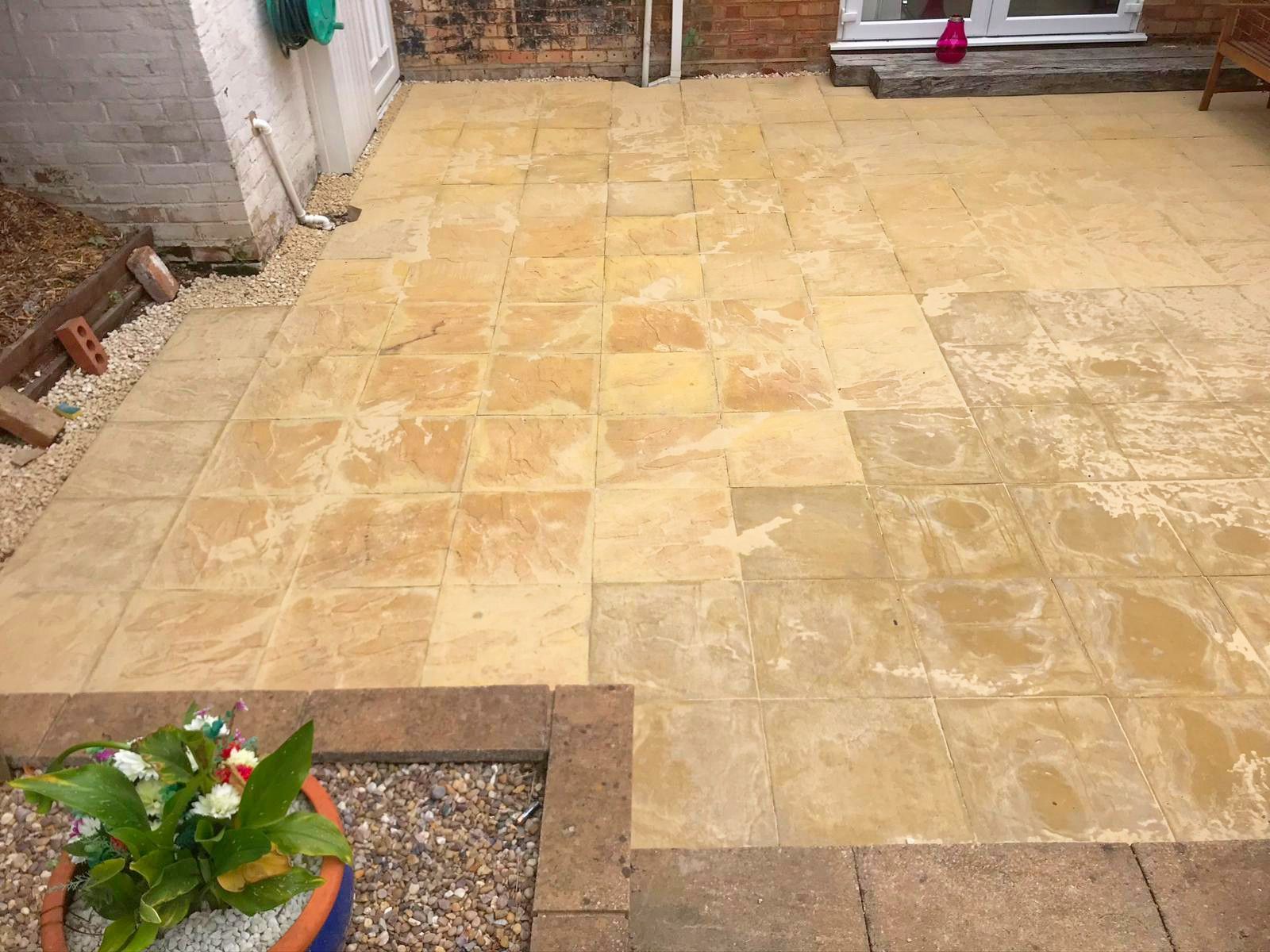 A new, large patio with a potted plant in the middle of it.