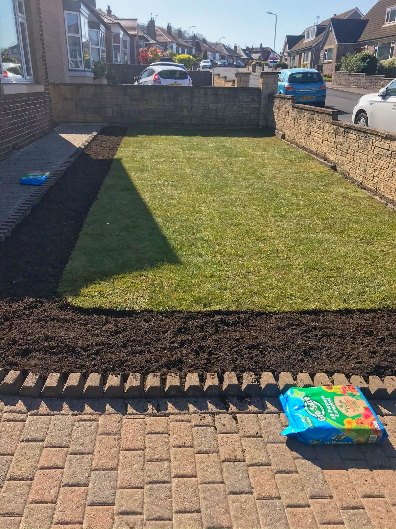 A new front-garden lawn with garden beds for new flowers to be planted.