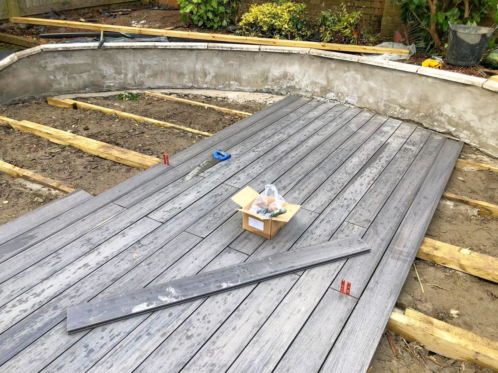 A box is sitting on top of a wooden deck under construction.