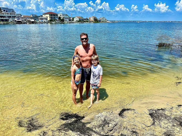 father with his children on shore