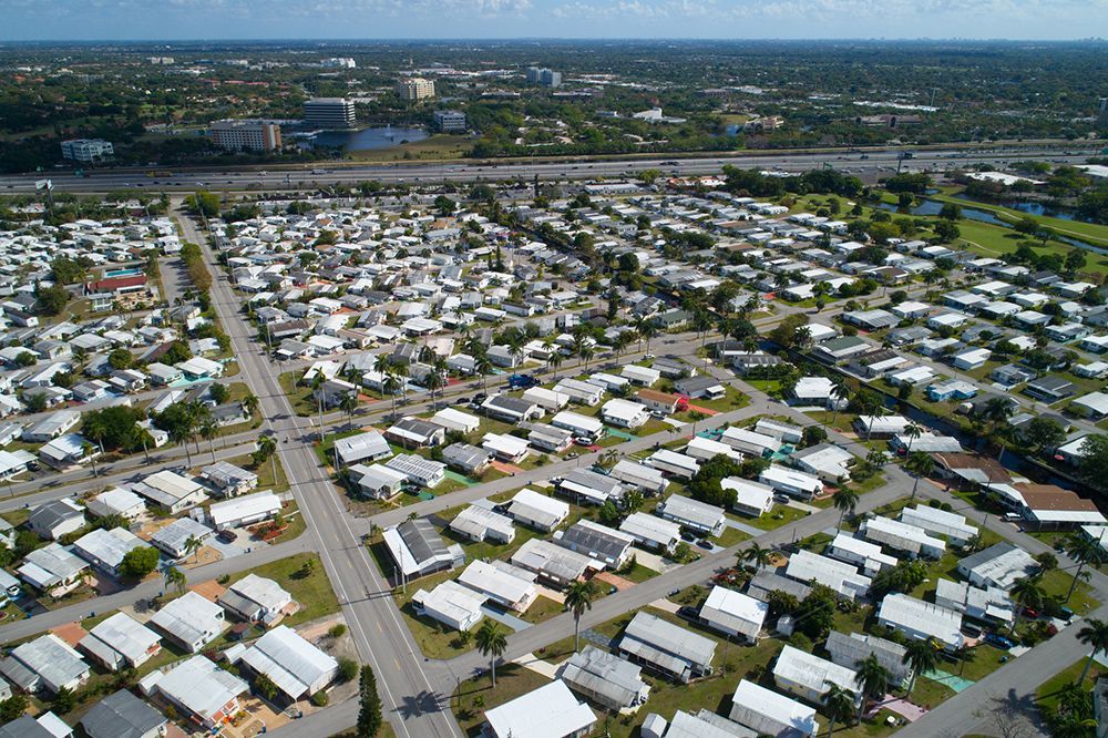 An aerial view of a mobile home park filled with lots of mobile homes.