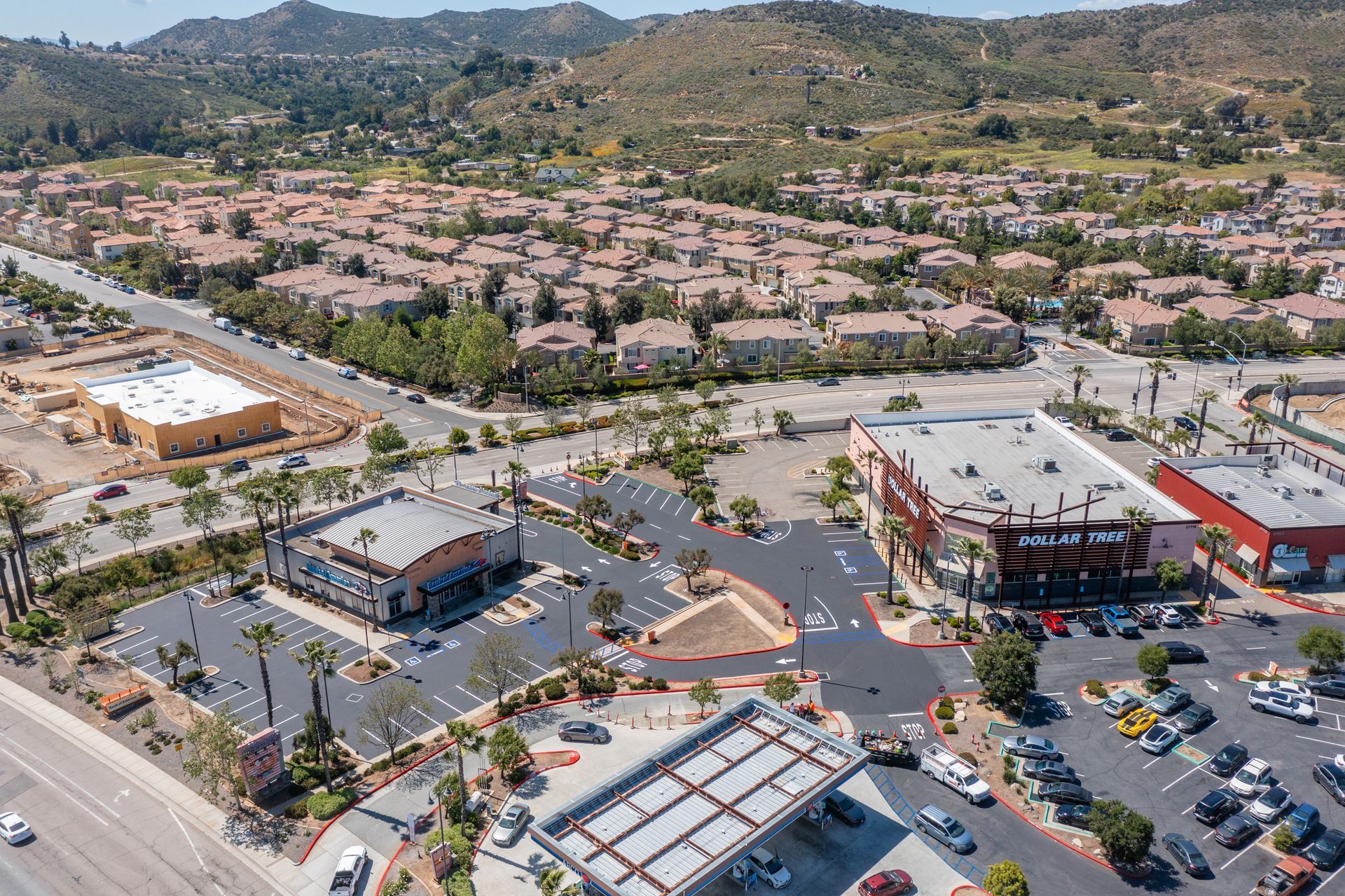 An aerial view of a city with a lot of buildings and parking lots.