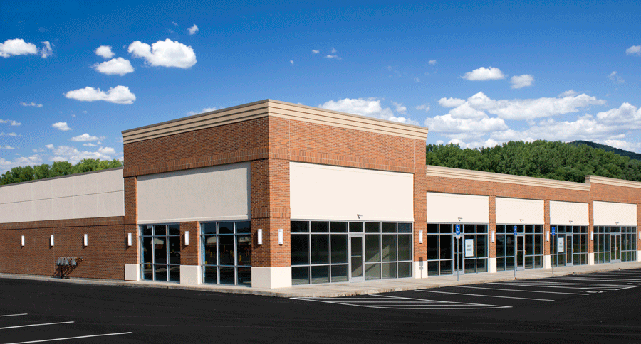 An empty highway with a city skyline in the background.