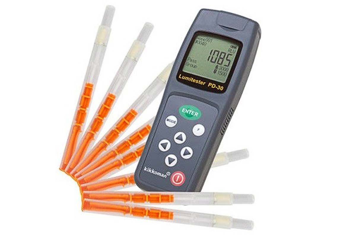 Digital meter with orange and clear probes, displaying