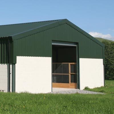 Green and white agricultural shed