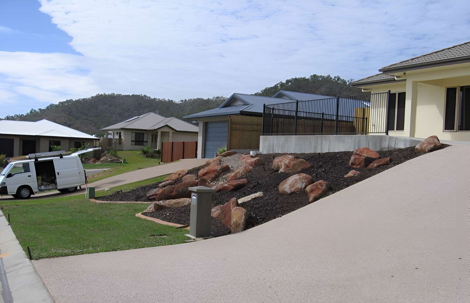 Front Yard House With Large Rock Design — Austen Landscaping & Earthmoving in Deeragun, QLD