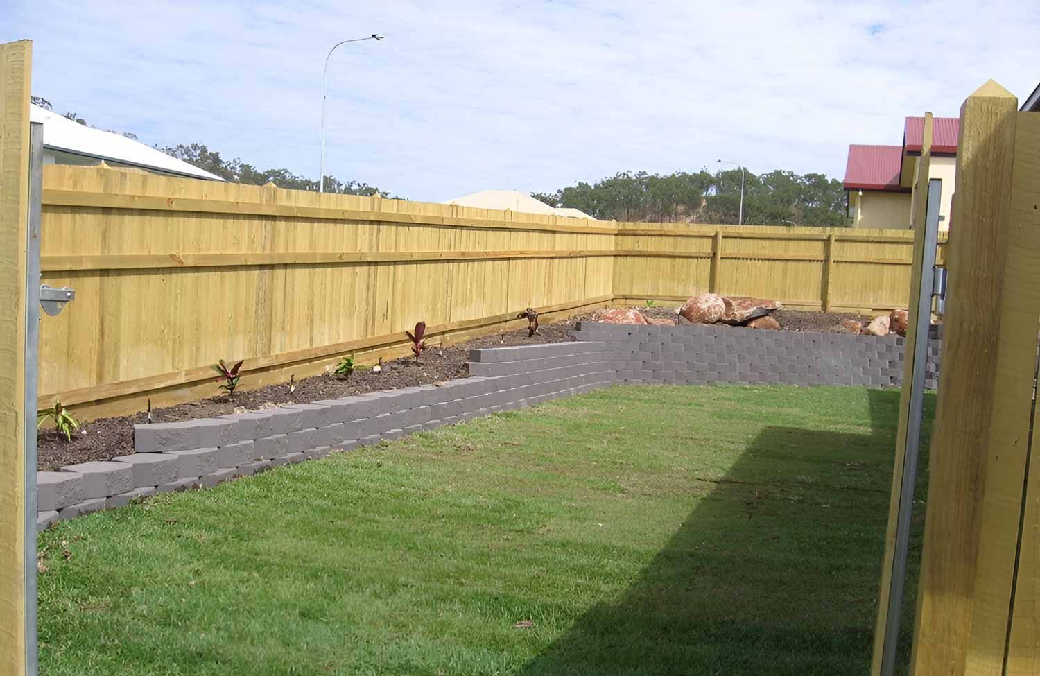 Backyard With Large Landscaping And Garden With Retaining Wall — Austen Landscaping & Earthmoving in Deeragun, QLD