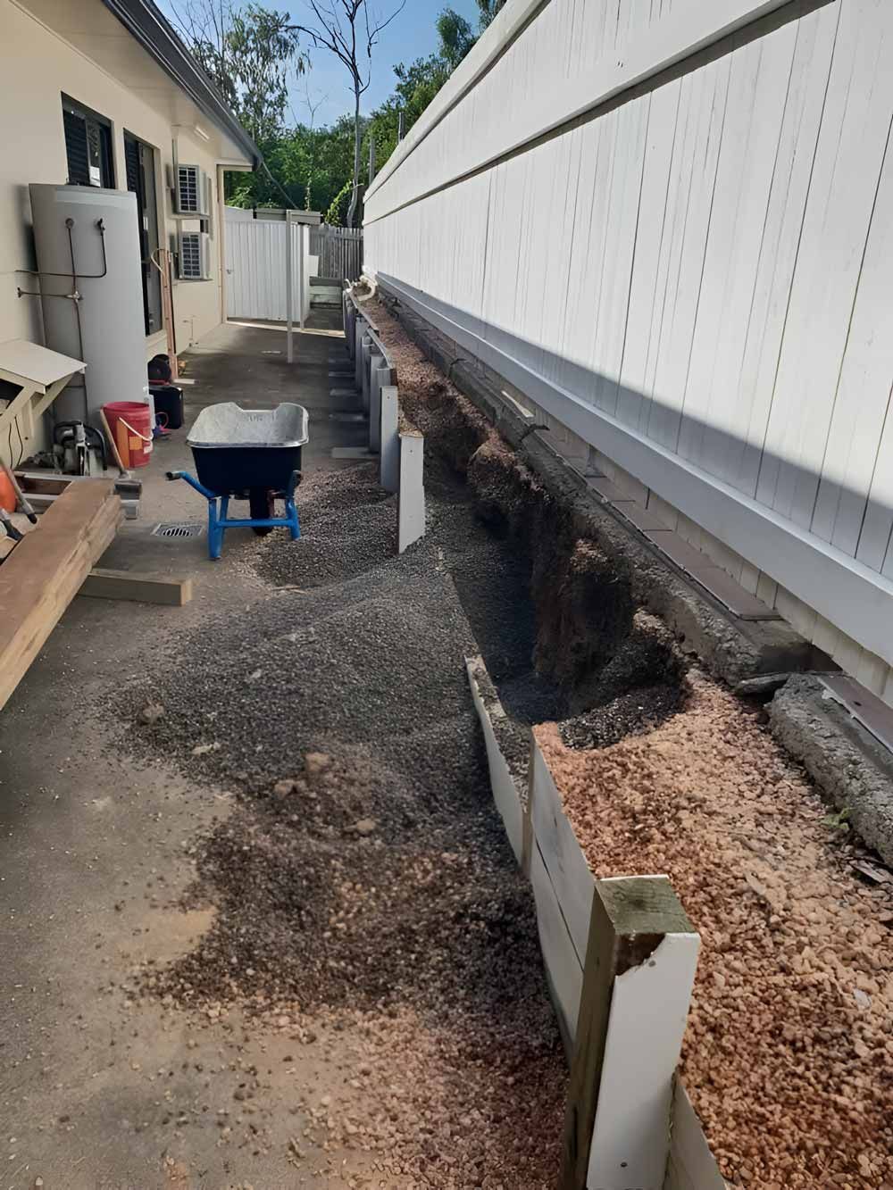 A White Fence Paired With A Wooden Garden Retaining Wall— Austen Landscaping & Earthmoving in Wulguru, QLD