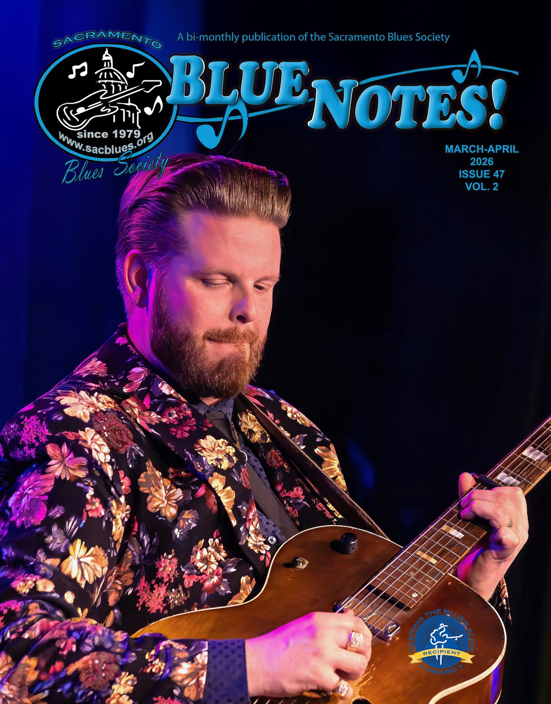 Man playing guitar under blue stage lights with “BLUE NOTES!” text above