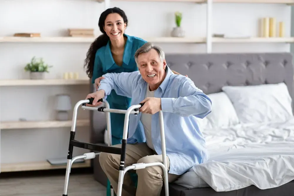 A Smiling Caregiver Assists a Man — CQ Home Care in Yeppoon, QLD