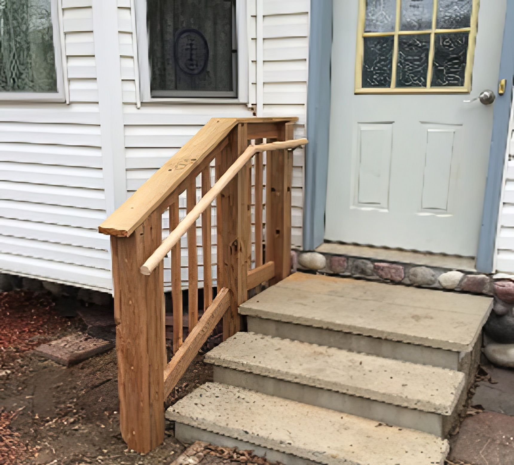 A wooden deck with chairs and a table under a pergola.