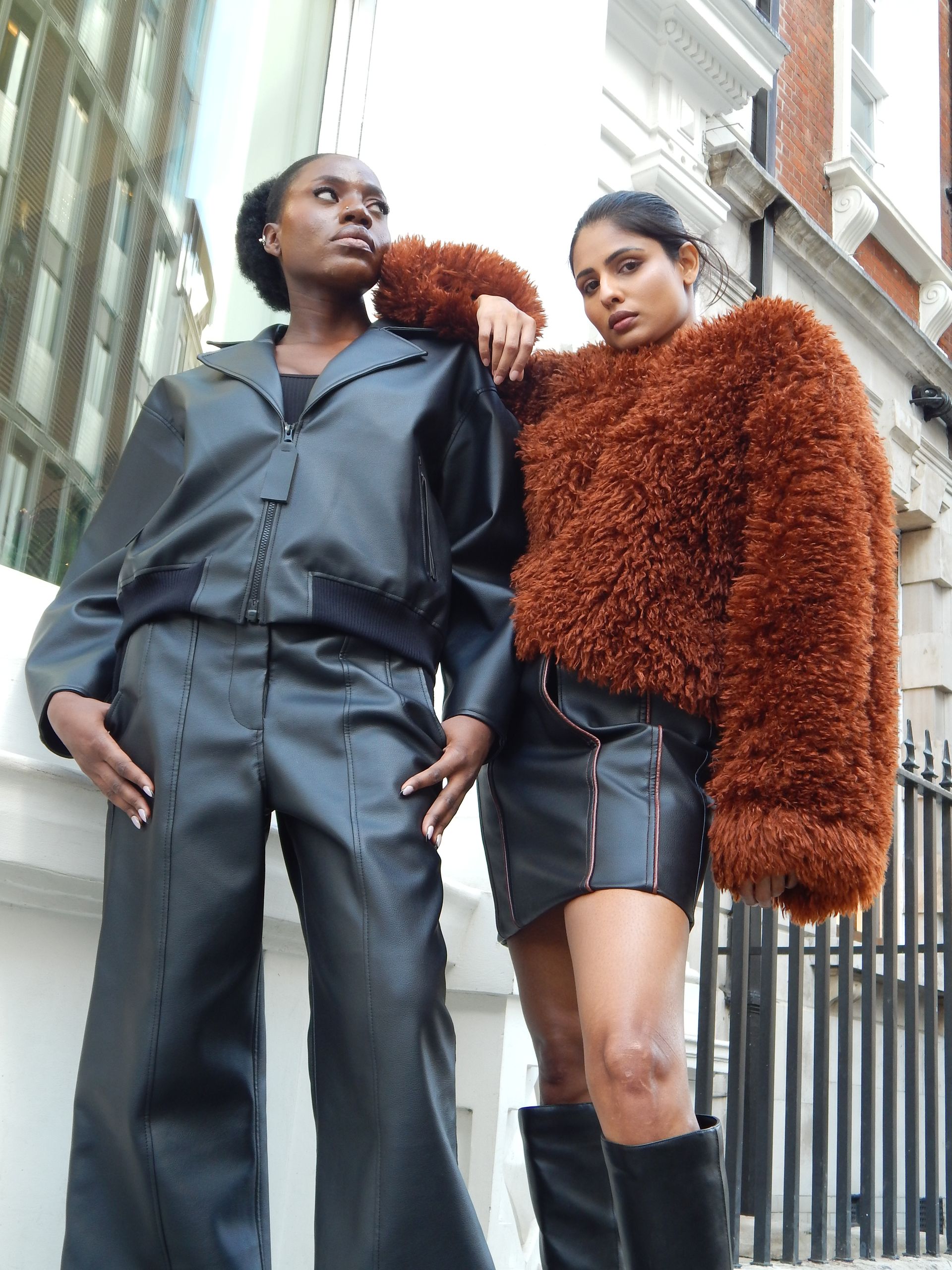Snake print ankle boots, light gray jeans, light wood floor.