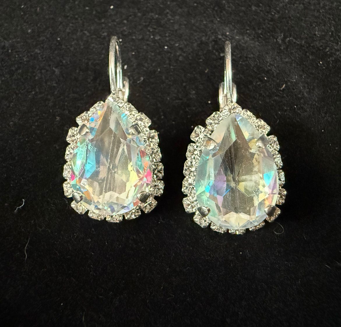 A pair of earrings with a clear stone in the middle