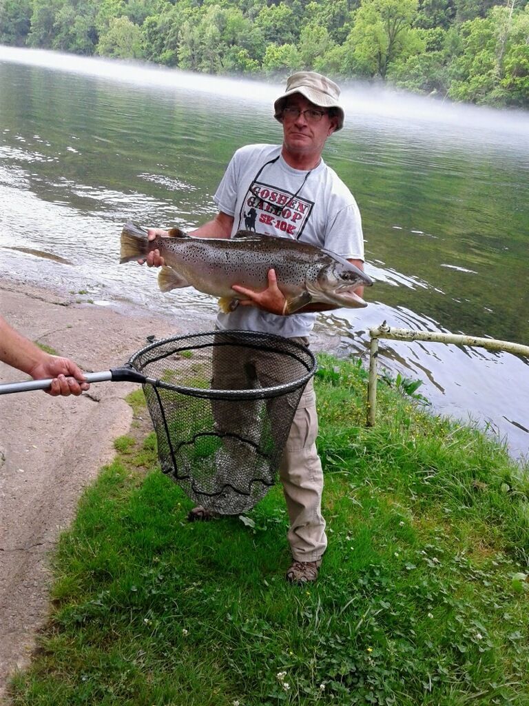 Guy with trout caught on white river while staying at cabin 5