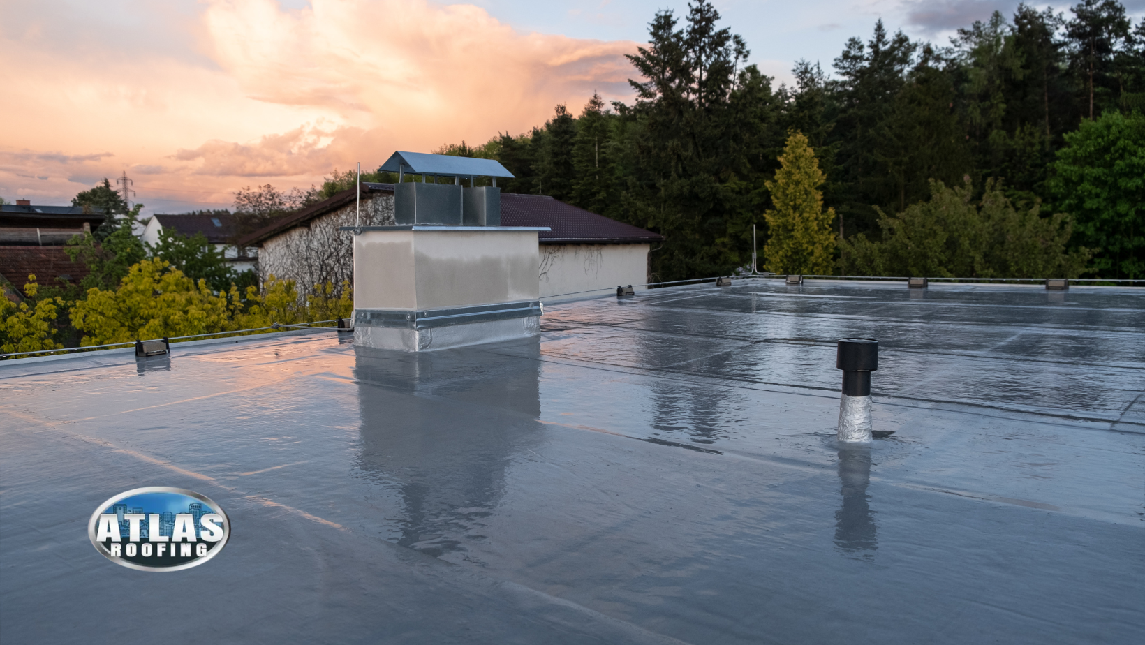 Flat commercial roof with a vent, under a cloudy sky.