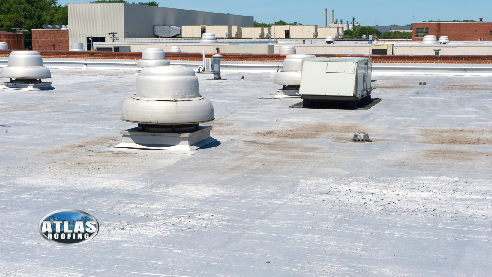 White industrial roof with vents and HVAC units.