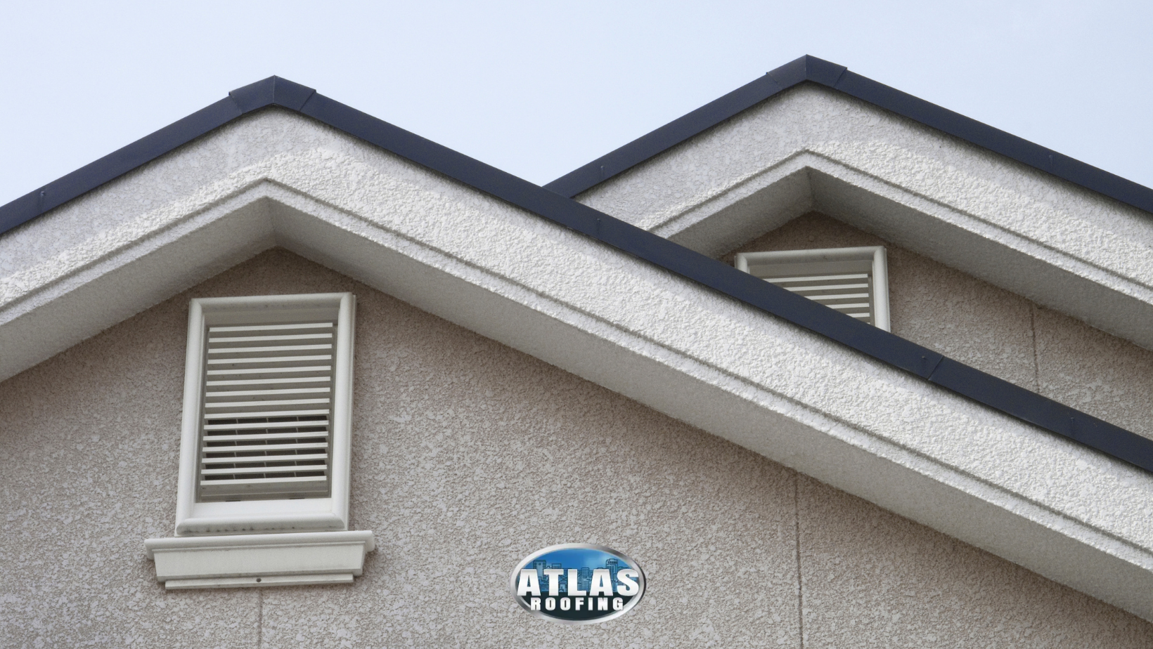 The attic ventilation and roof of a building with a sign that says atlas roofing.