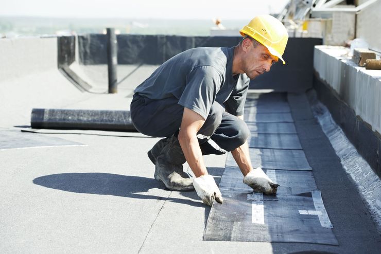 View of commercial roofer working on roof