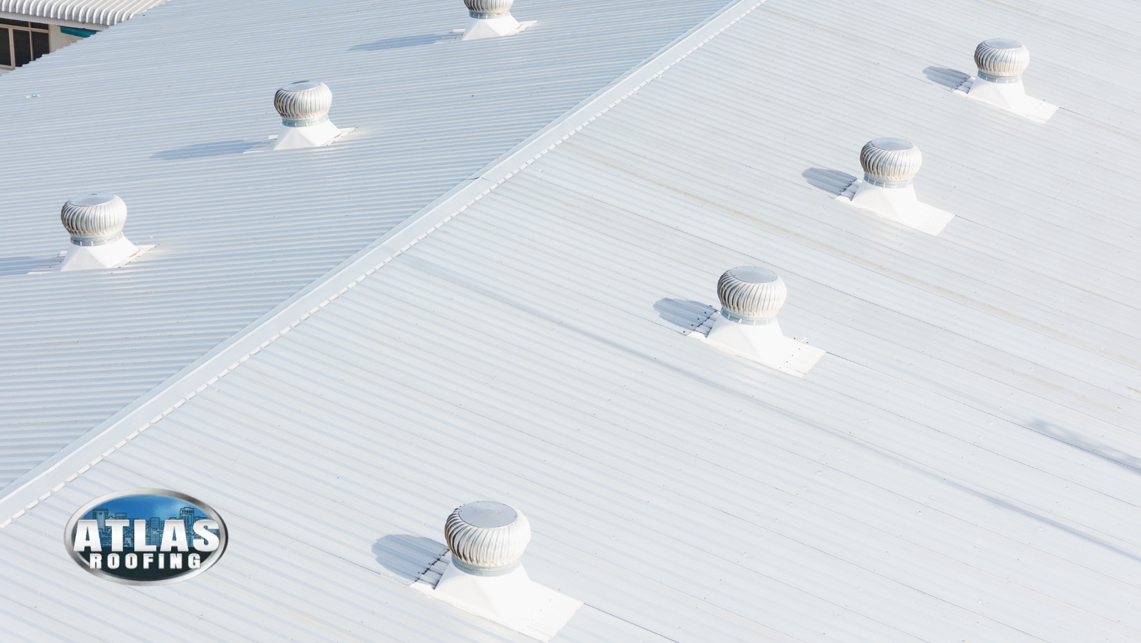 A white roof with a lot of vents on it. Atlas Roofing.