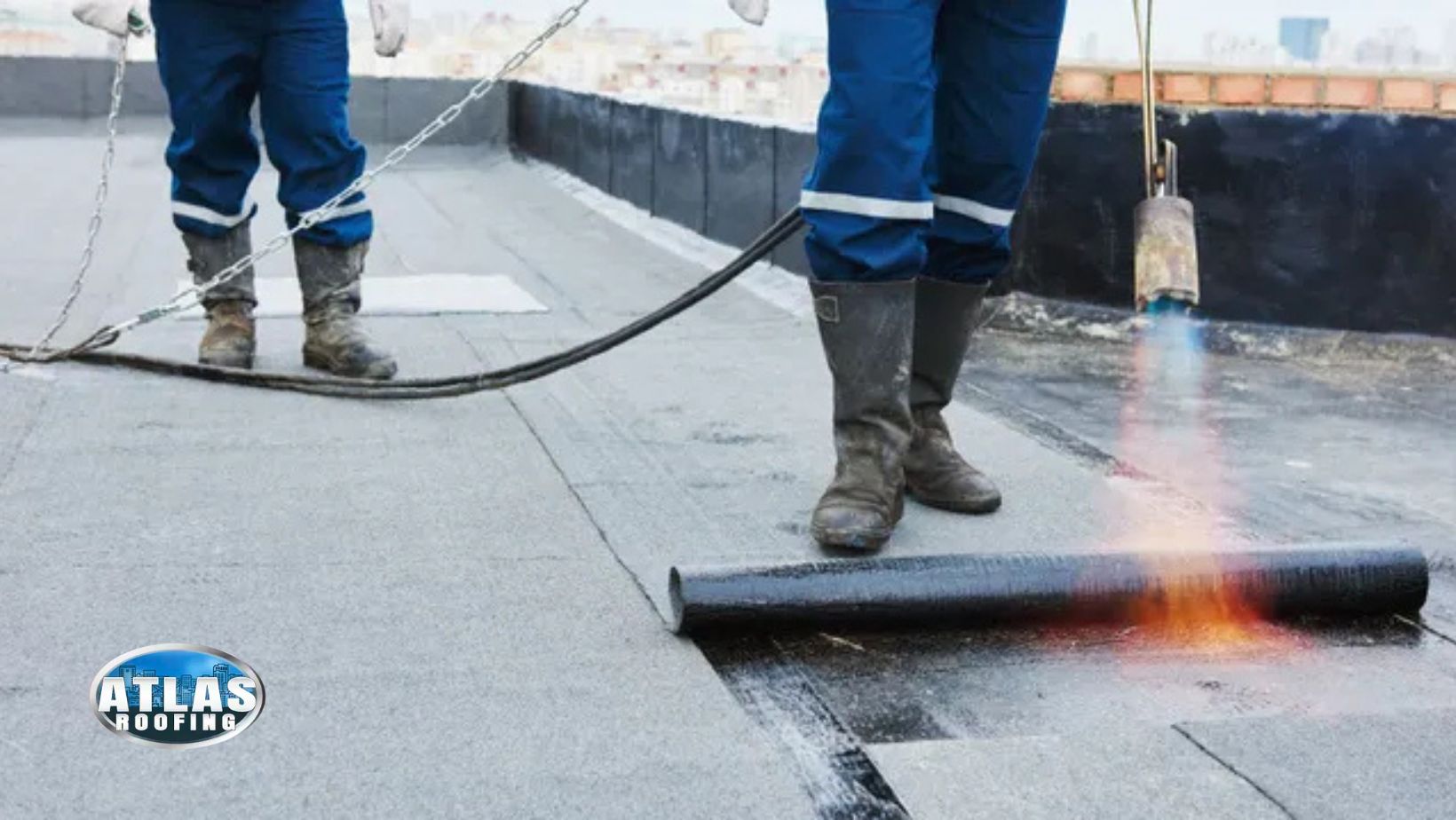 EPDM roofing. A man is using a torch to apply waterproofing to a roof.