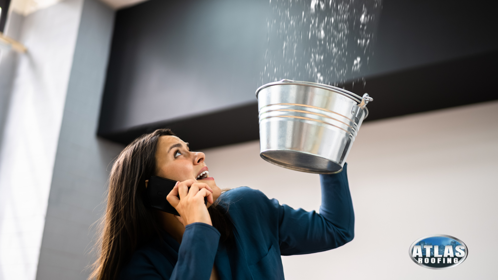 A woman is holding a bucket over her head catching water from a leak.