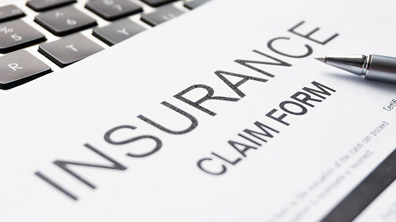 Insurance claim form lying on keyboard