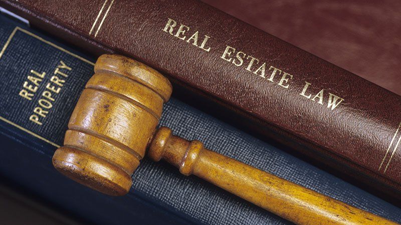 gavel lying on real estate law books