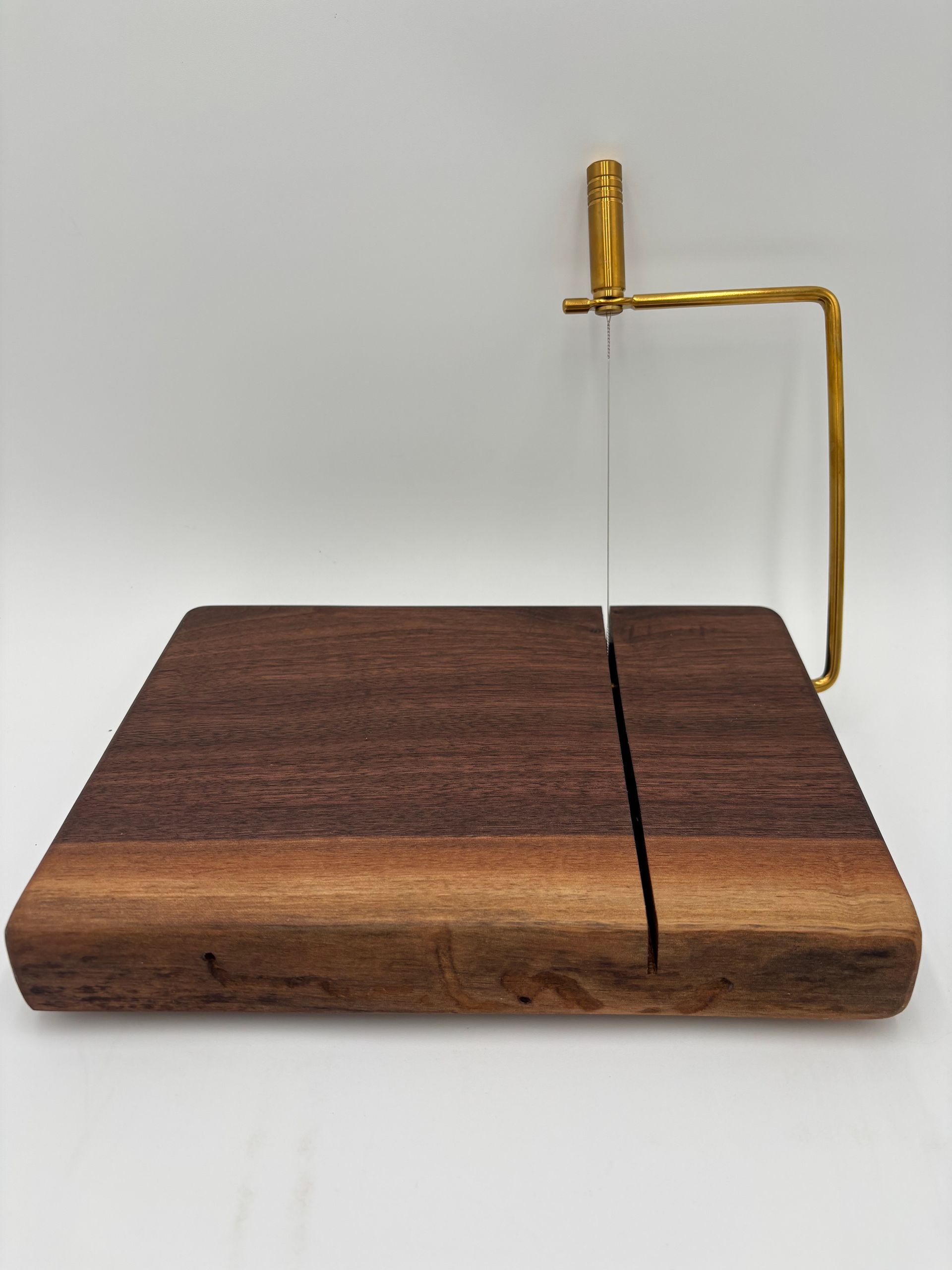 Black walnut cheese slicer with gold handle