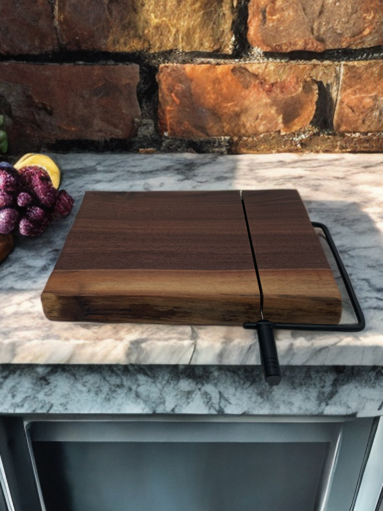 A wooden cutting board is sitting on top of a marble counter.