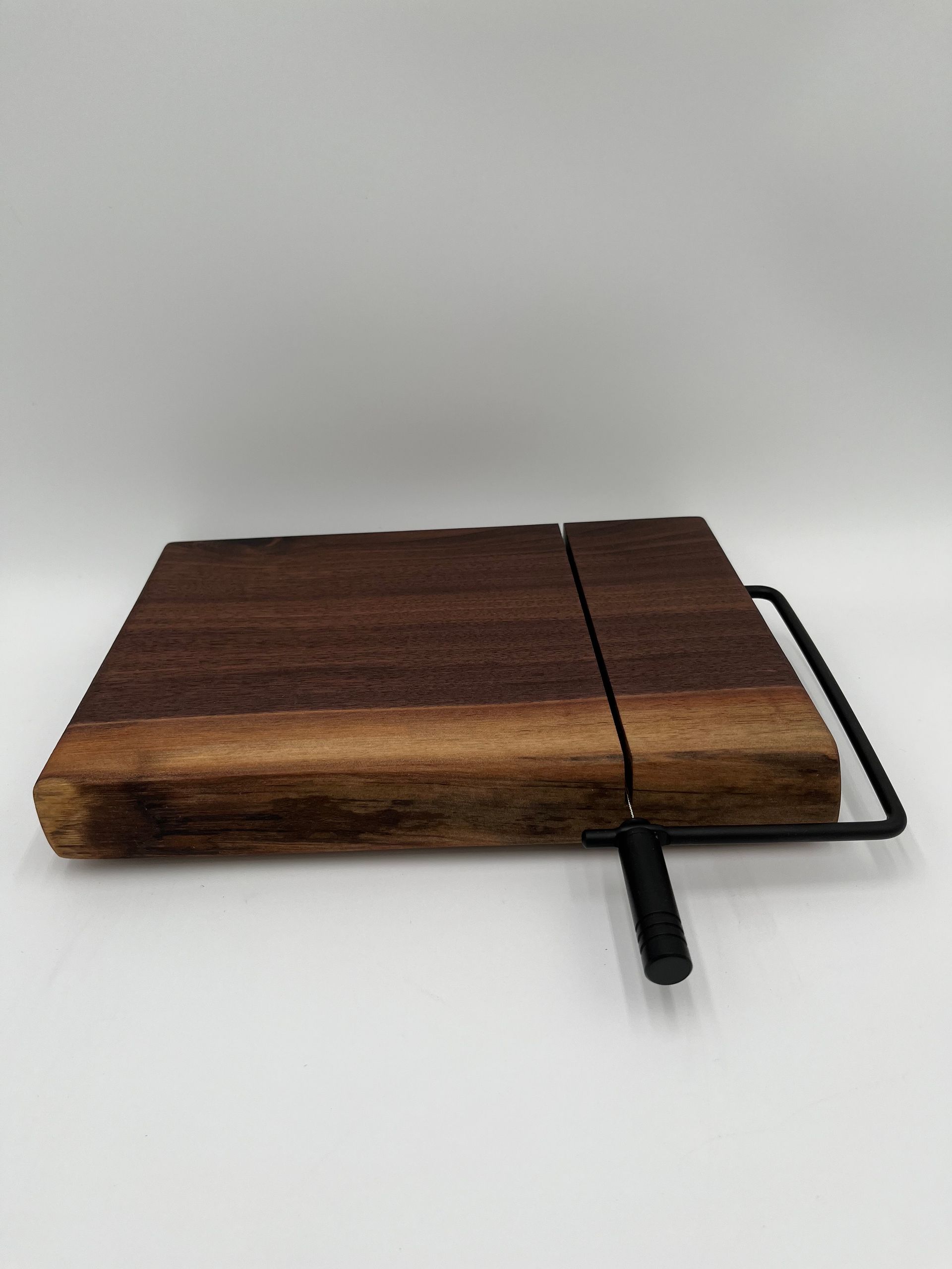 A wooden cutting board is sitting on top of a marble counter.