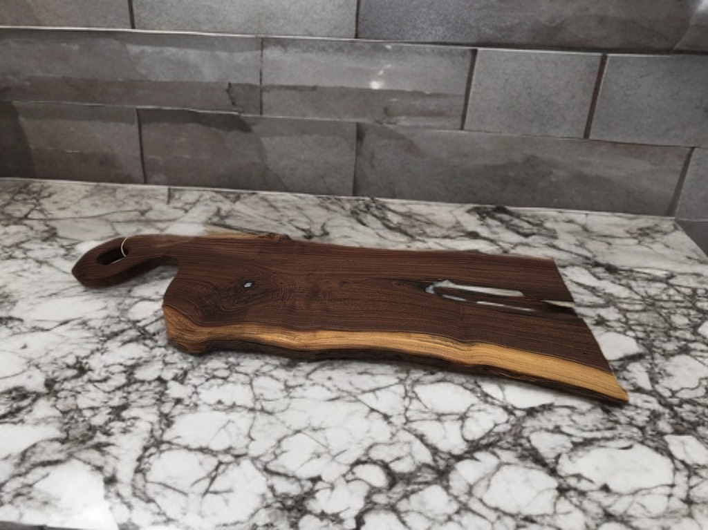 Wooden cutting board on a white and gray marble countertop with a gray brick backdrop.