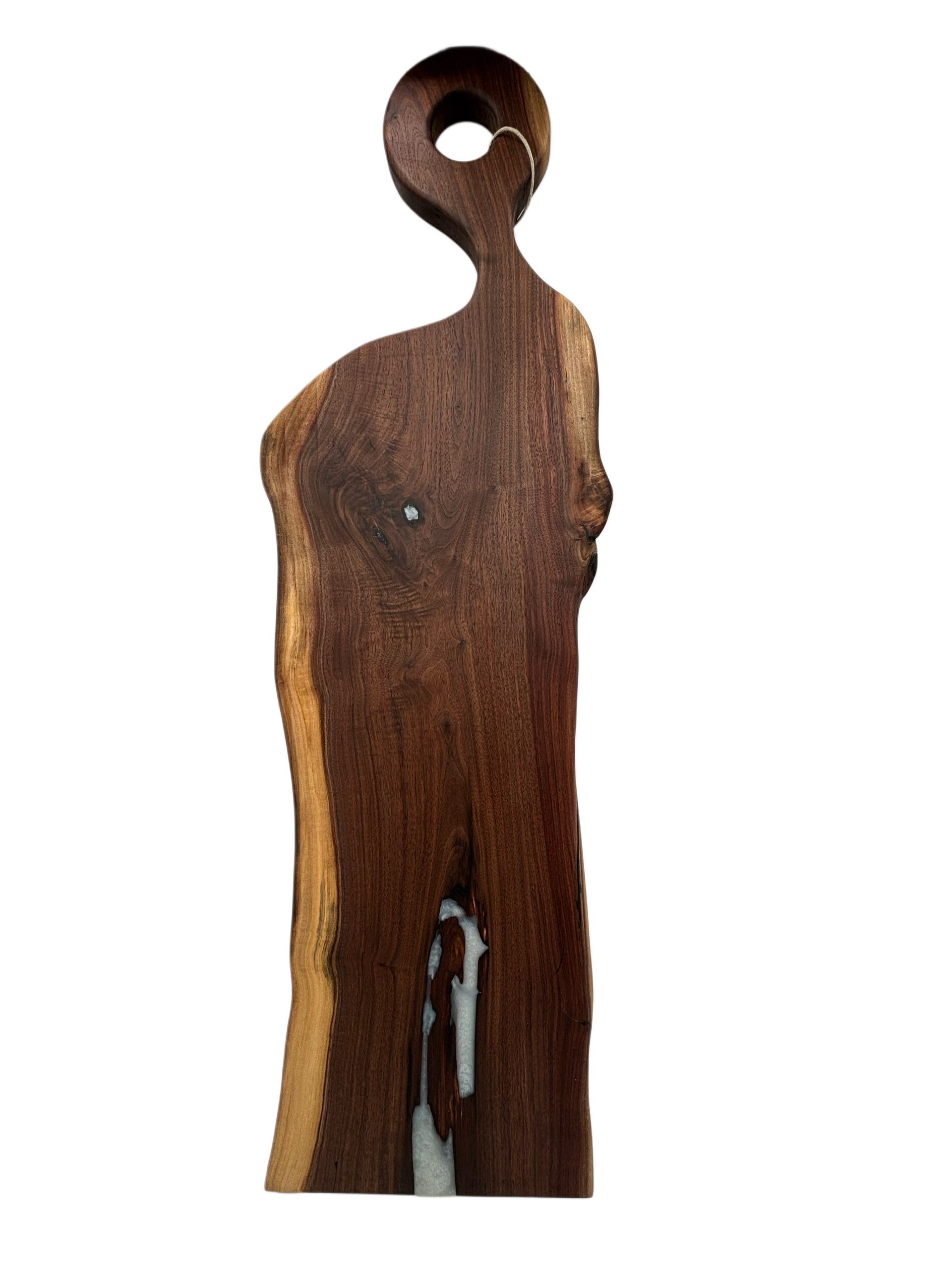 Wooden cutting board with live edge and handle. Dark brown with a light edge.