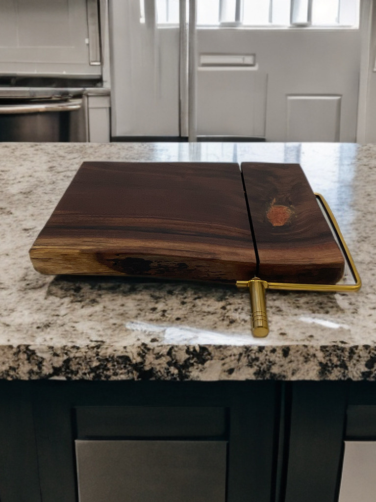 A wooden cutting board is sitting on top of a granite counter.