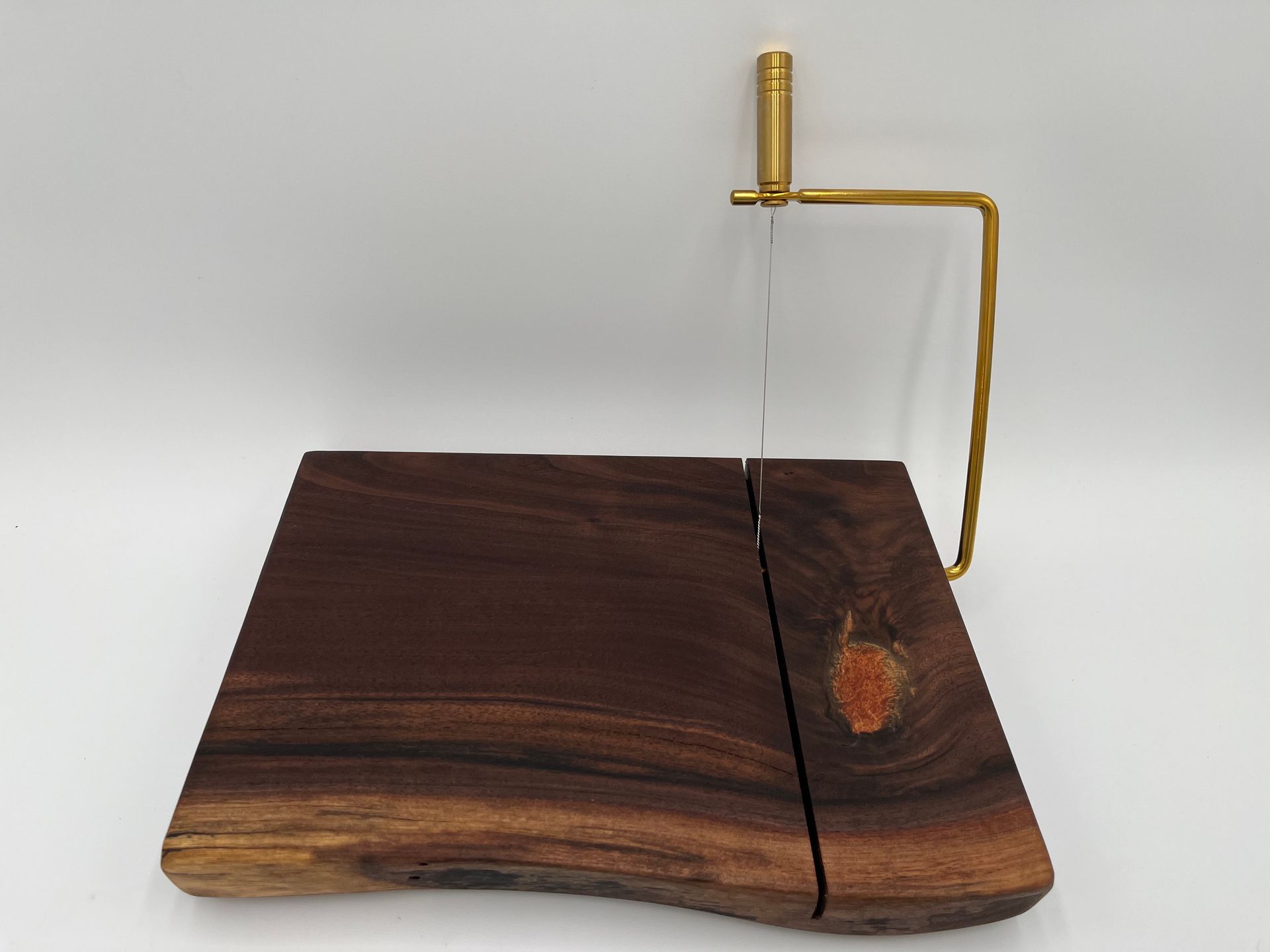 A wooden cutting board with a cutting tool on it