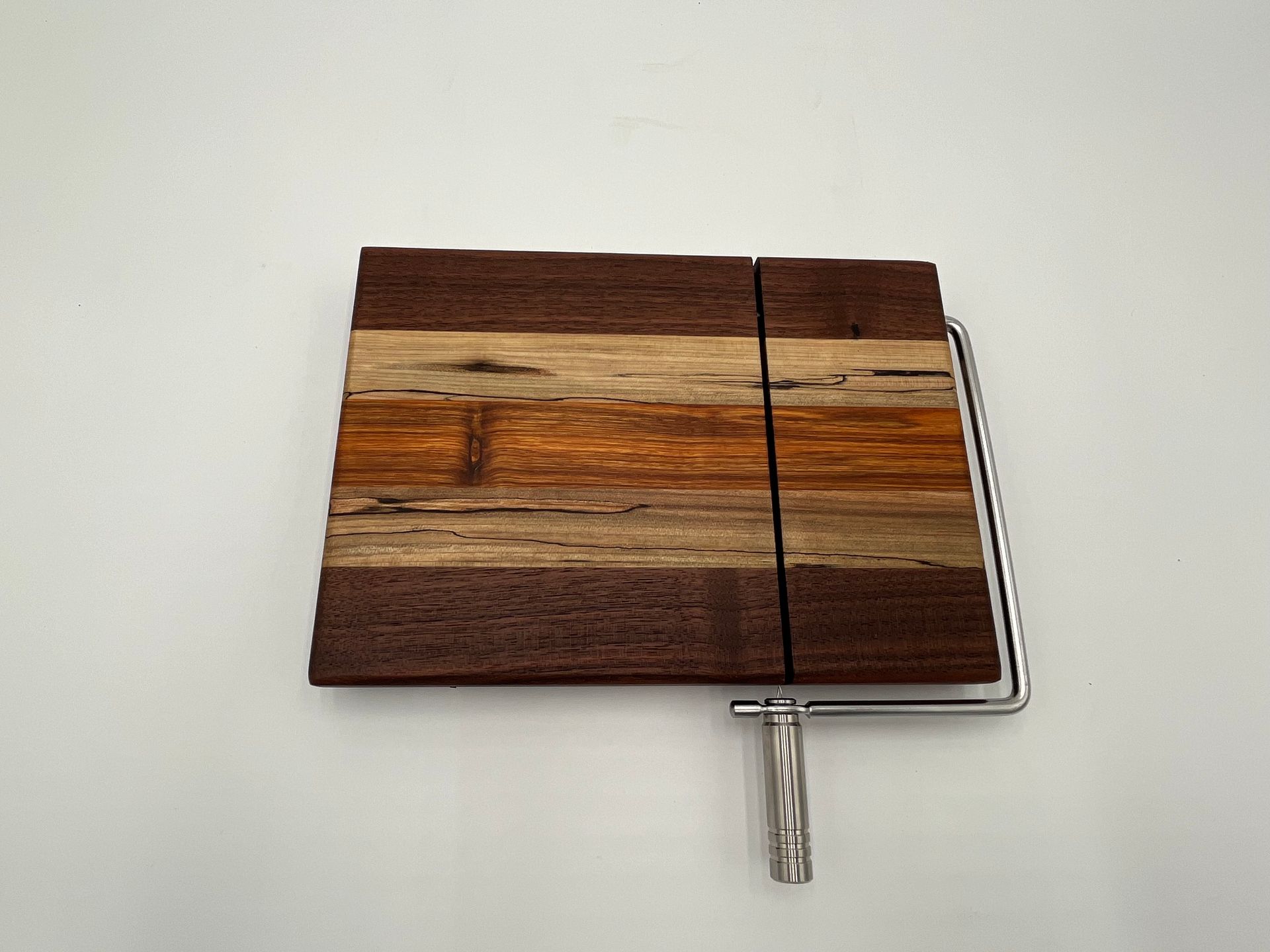 A wooden cutting board is sitting on top of a marble counter.