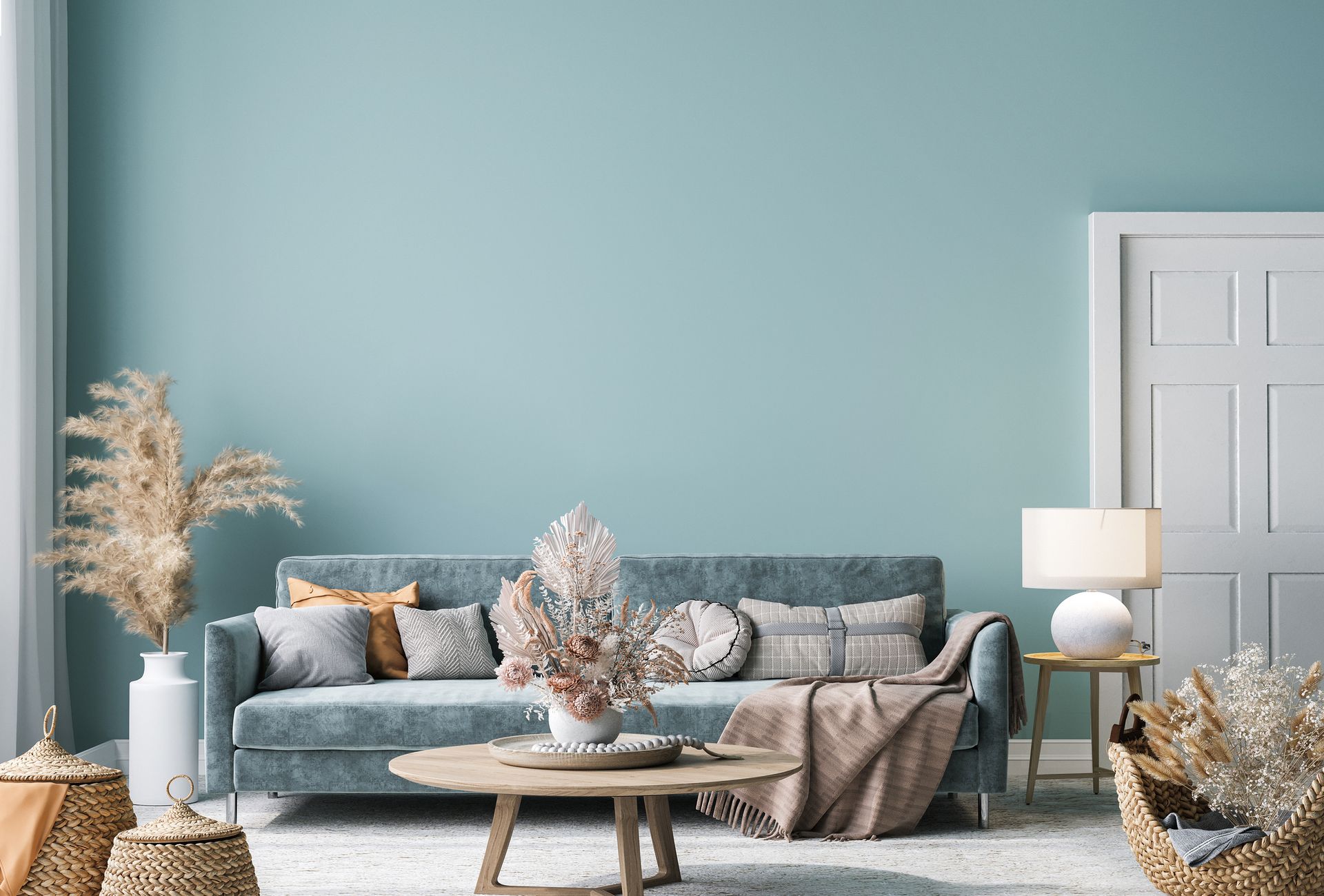 A living room with a couch , table , chairs and blue walls