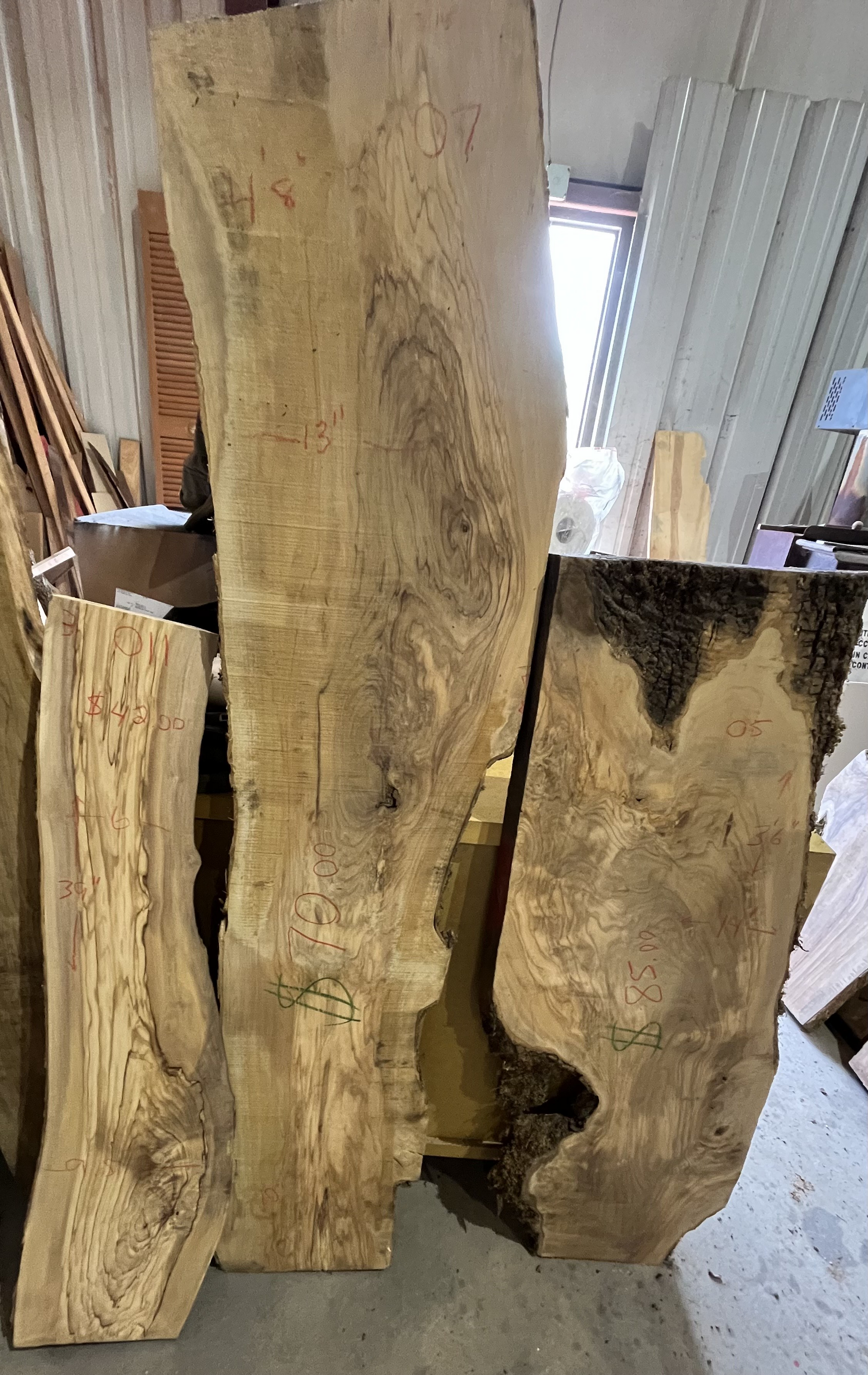 A pile of wood pieces sitting on top of a concrete floor.